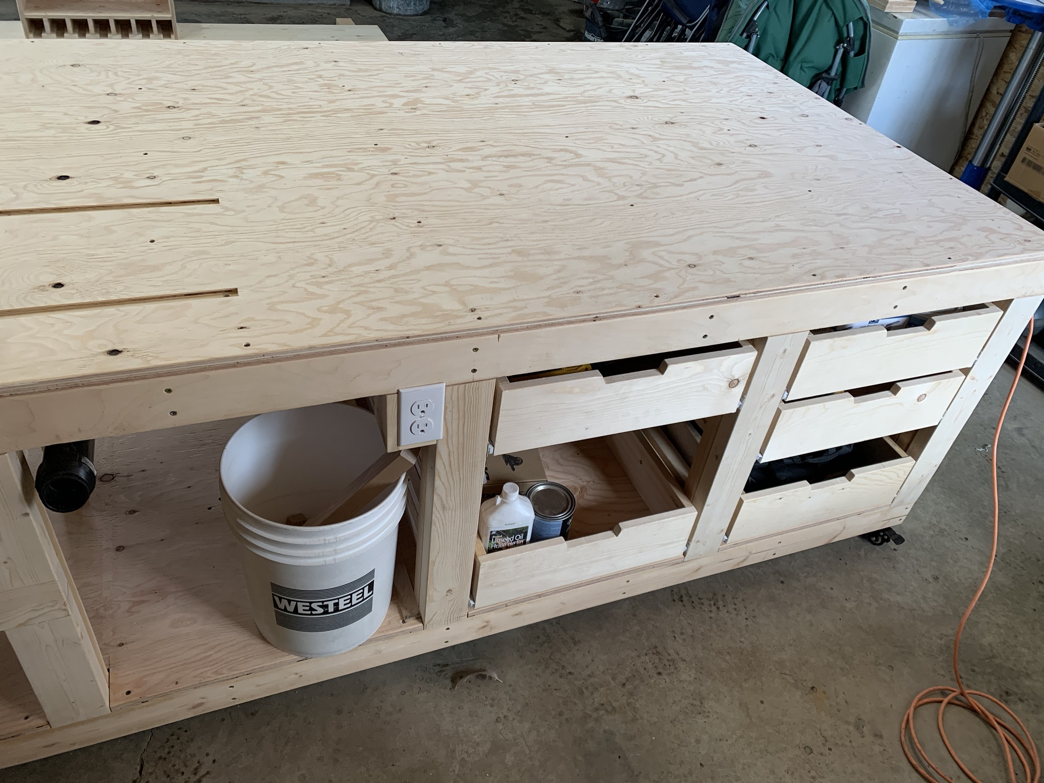 Completed woodworking workbench with storage and tools